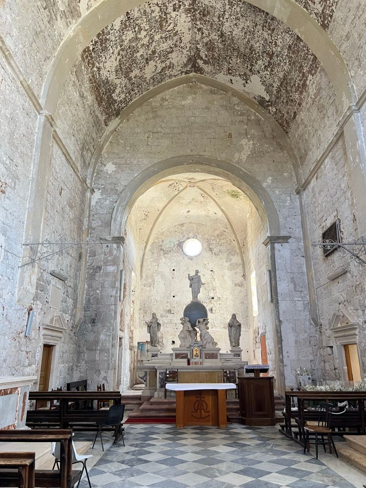 Wider range view of the whole soaring chapel where the cat is sleeping on the chair