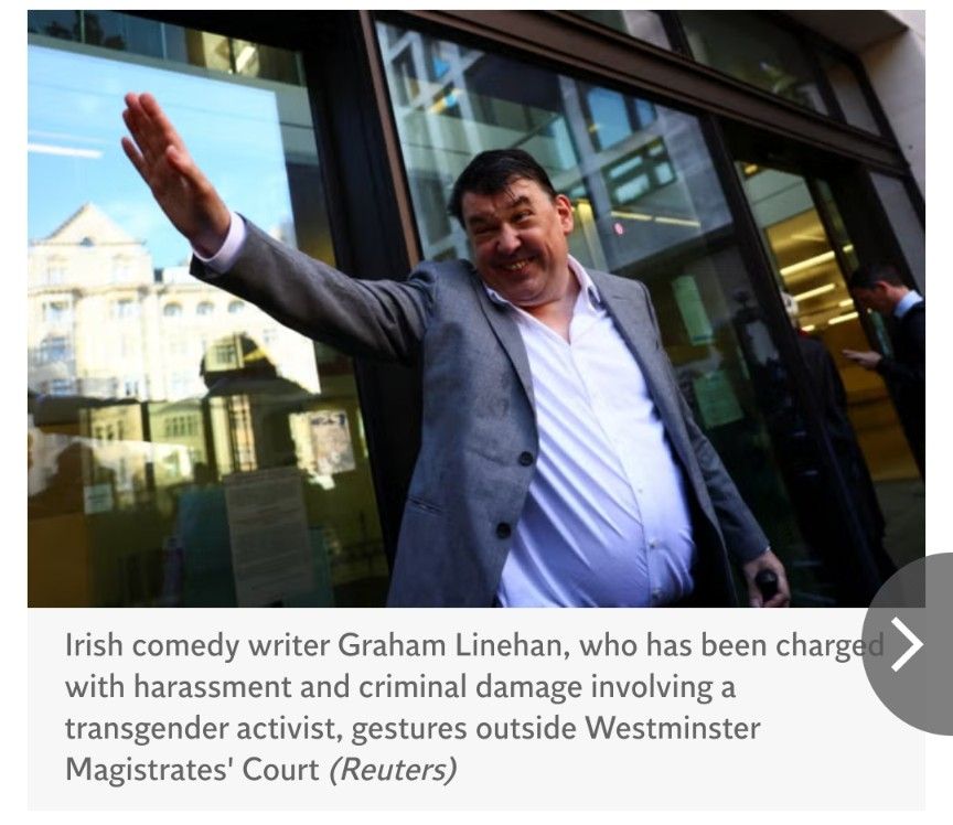 A photo credited to Reuters of anti-trans bigot Graham Linehan, outside Westminster Magistrates' Court. He's facing charges of harassment and criminal damage against a young trans woman.

In the photo, one of the most divorced middle-aged white cis straight men in the world is wearing a white shirt (open at the neck, no tie) and a grey suit jacket, open. Behind him are a plate glass window and automatic door, which reflect buildings in sunlight. Linehan's expression is probably meant to be a smile, but it looks more like a gurning approximation of whatever a black soul; wizened by years of focused hatred and emptiness, would think a smile is. His right arm is raised in what is described in the Independent's photo description calls a "gesture": straight arm and all fingers extended. I don't think he has a heart to go out to anyone - not that Elon Musk does, either.

He's pleaded not guilty, btw; even though Sophia recorded the harassment on the day of the criminal damage, and video of him throwing her phone across the road exists and will likely be entered into evidence.