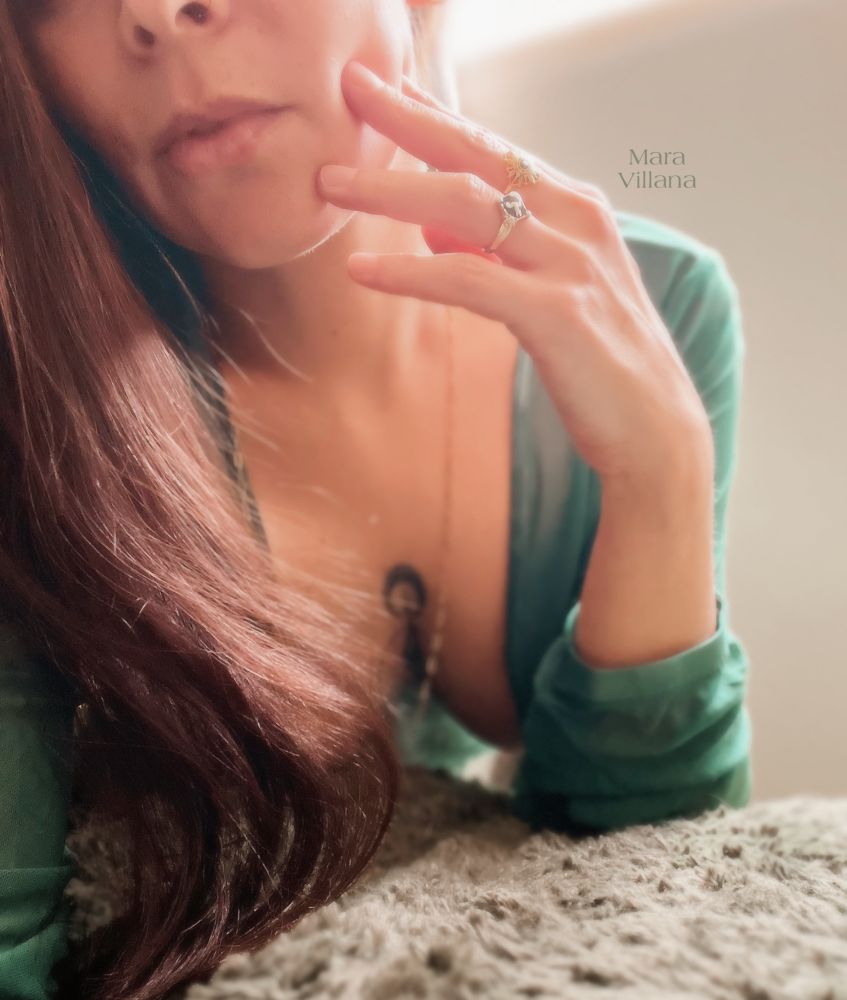 Mara Villana in a sheer green robe, leaning in close. 