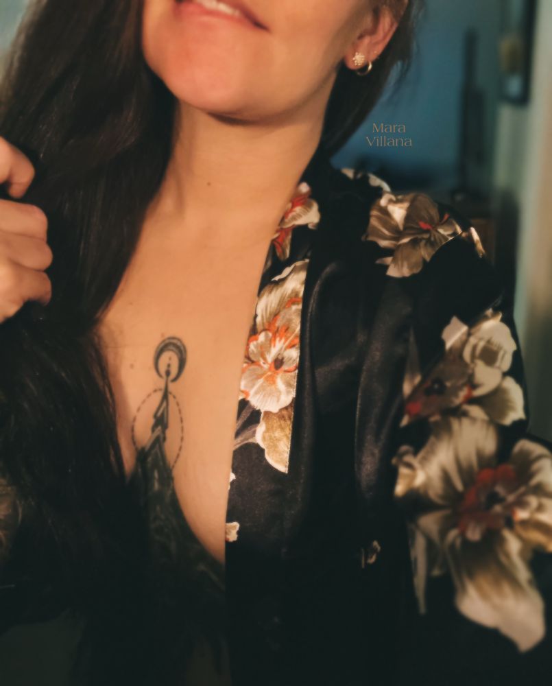 Mara Villana wearing a floral silk robe, biting her lip and letting just enough skin to tease and taunt. 