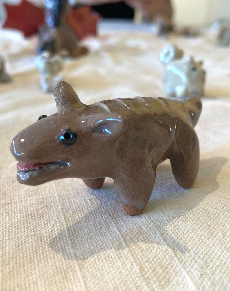 close up of dark brown ceramic dog that looks like a loaf of bread