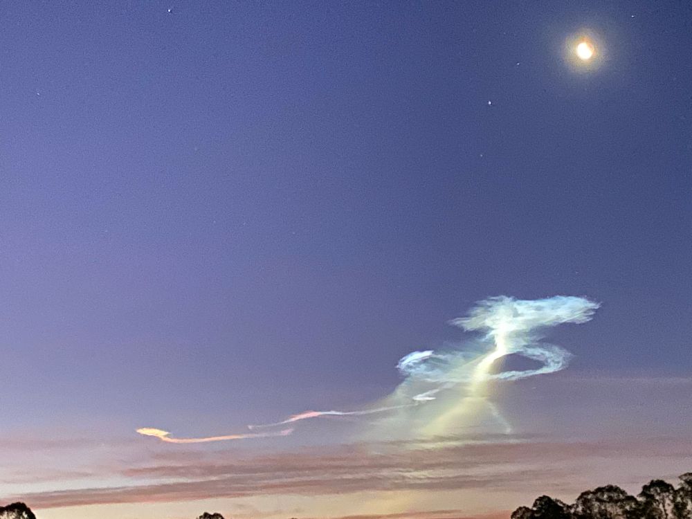 Unusual vapor formation in the sky lit by pre-dawn light. 