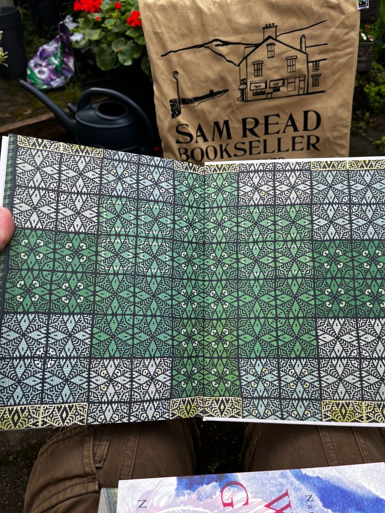 The endpapers of the book Crochet Squares by Maria Gullberg showing a blanket inspired by William Morris, made up of various crochet squares in varying shades of green, with repeating patterns of a graphic and botanical nature. 