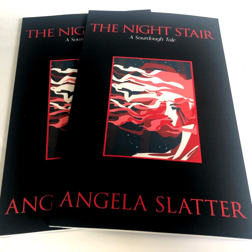 Two copies of Angela Slatter's Chapbook, The Night Stair, resting on a white tabletop. 