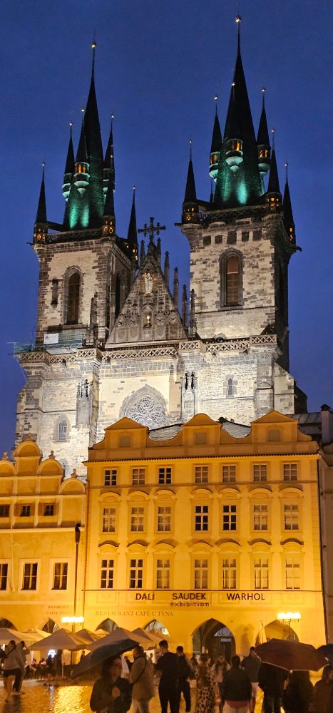 The gothic Catholic church of the Mother of God before Týn, seen from the Old Town square at night.