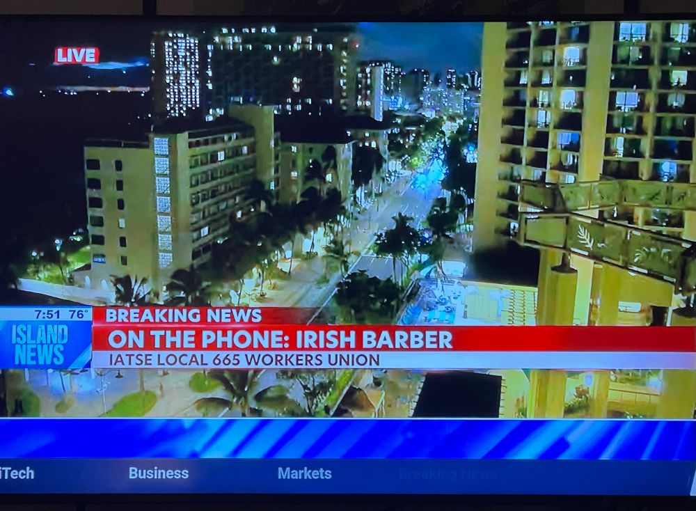 tv screen from local Hawaiian news for tsunami watch, shows speaker calling in on the phone is local IATSE rep with the name: Irish Barber