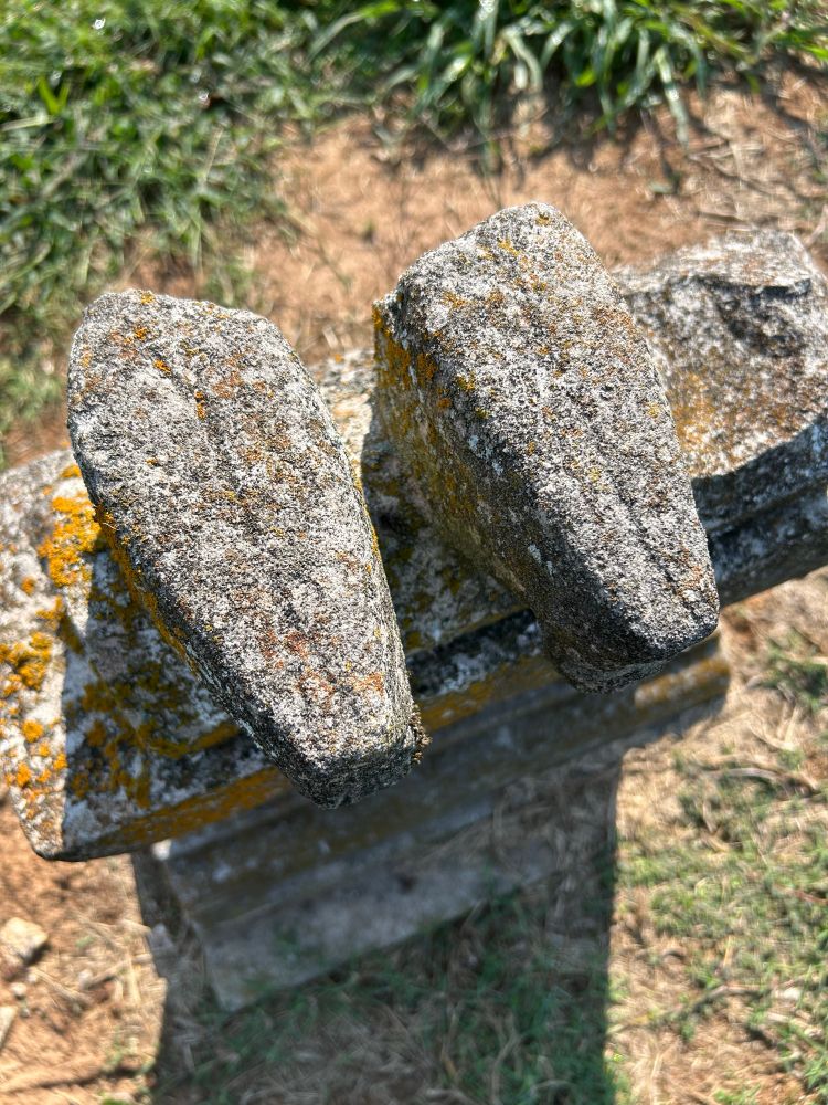 Stone bird shapes with carved wings. 