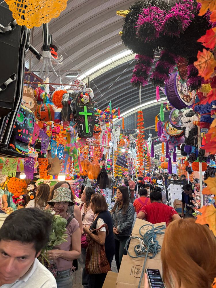 Busy Jamaica Market full of people and dis de los muertos decorations 