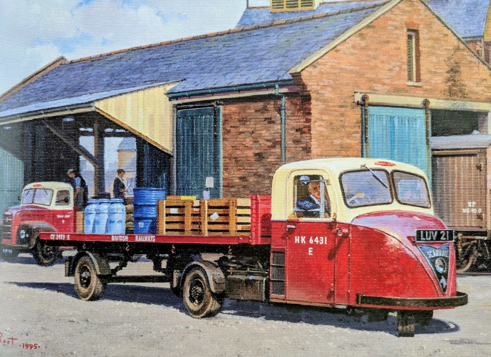 A Scammell Scarab "mechanical horse" in cream and maroon British Railways livery.  The three-wheeled tractor unit tows a flat bed trailer carrying an assortment of goods.  Behind, in the goods shed, is a Ford Thames 2-ton truck.