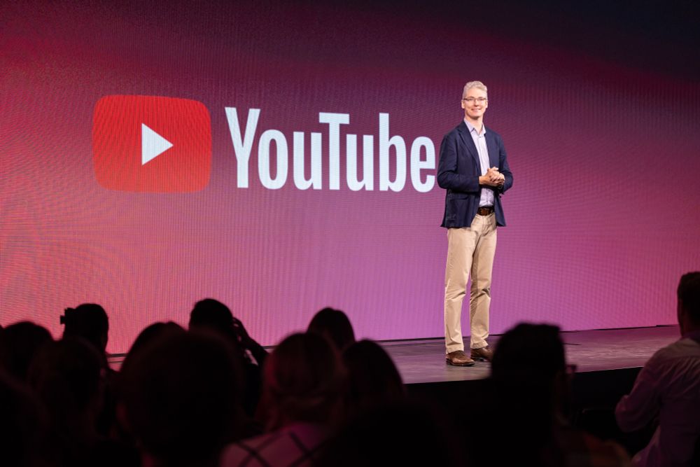 Google senior director David Black on stage in front of a YouTube logo.