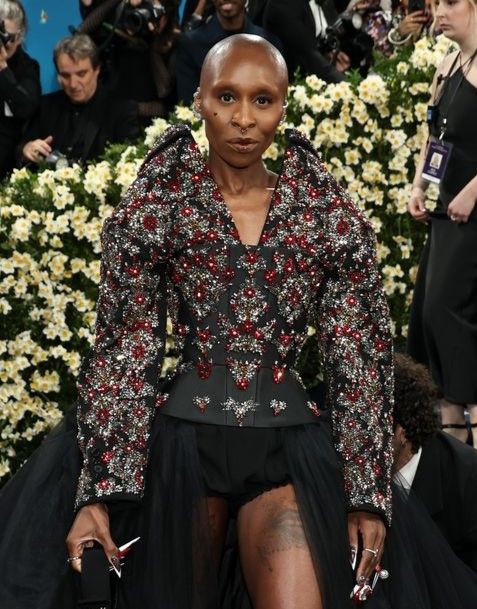 Cynthia Erivo in a black and red dress. Photo copyright Harpers Bazaar