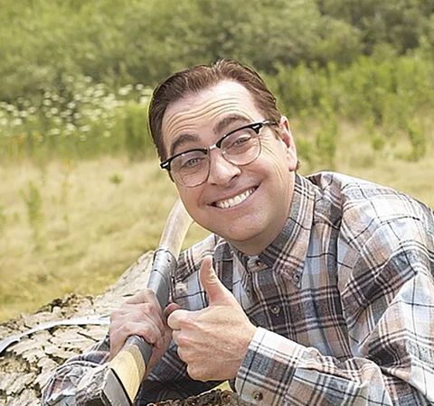 Harold Green with an axe smiling in flannel and giving the thumbs up