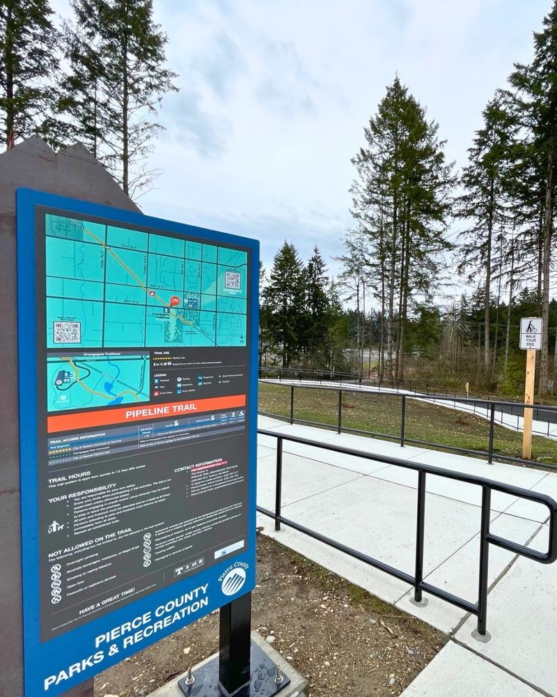 Trail sign next to a newly paved trail.