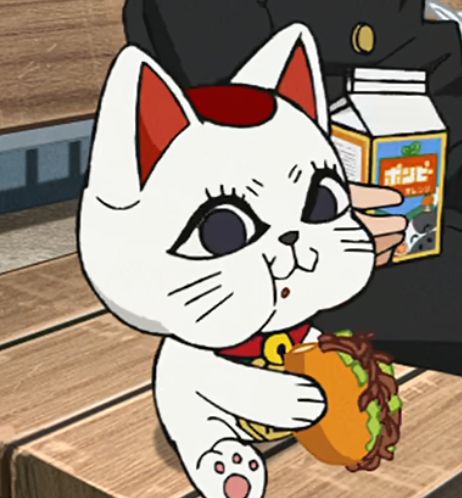 Turbo Granny, a character from Dandadan who takes the form of a living Maneki-neko Doll, eating a sandwich