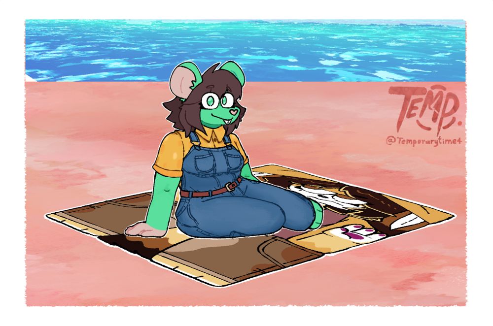 Applesauce relaxing on a Silver towel at the beach