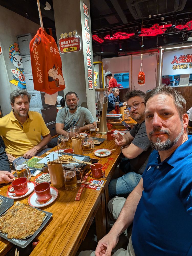 Just some dudes and a table of Chinese food