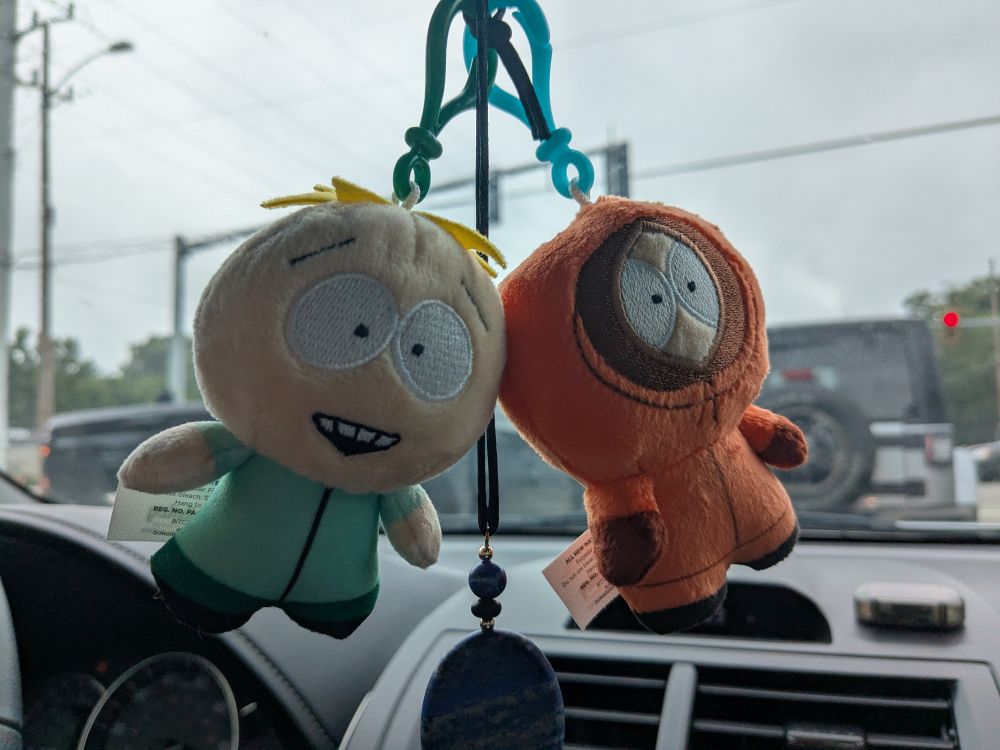 butters and Kenny from South park small plushies hanging from car mirror 