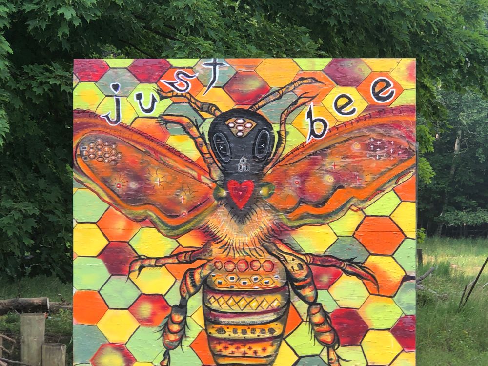 Art of a bee with the text “Just Bee” written over it