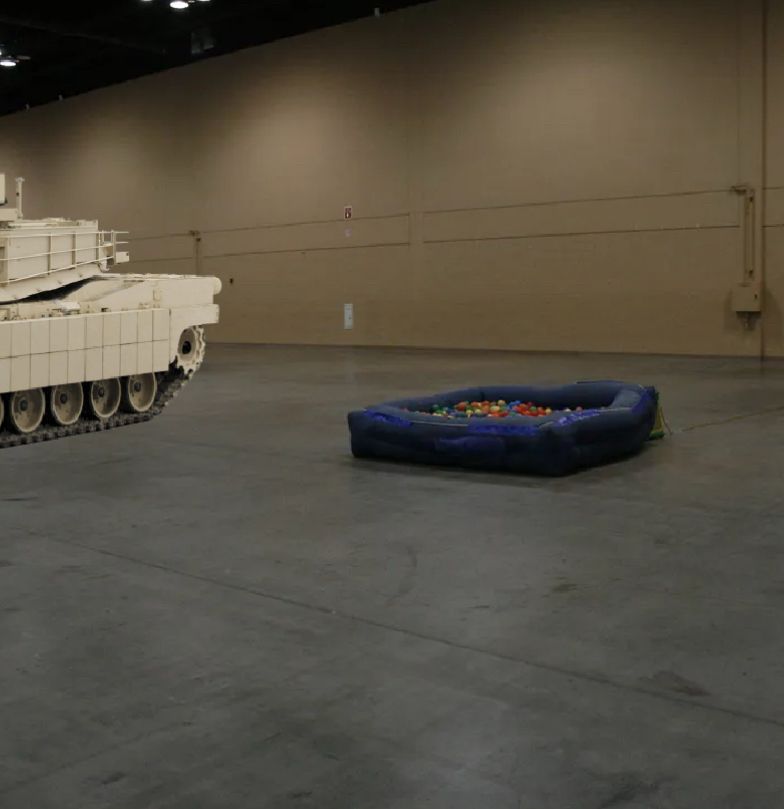 dash on ball pit with an abrams tank in the background