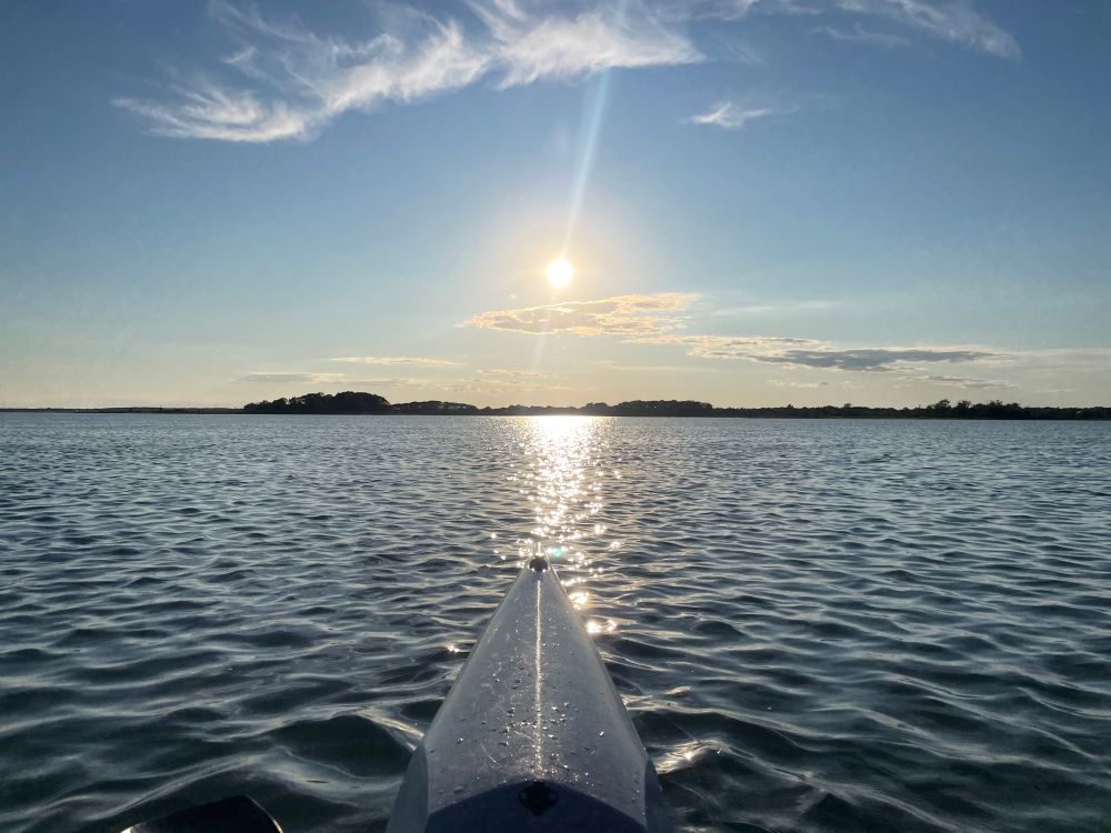 Low sun over kayak bow. 