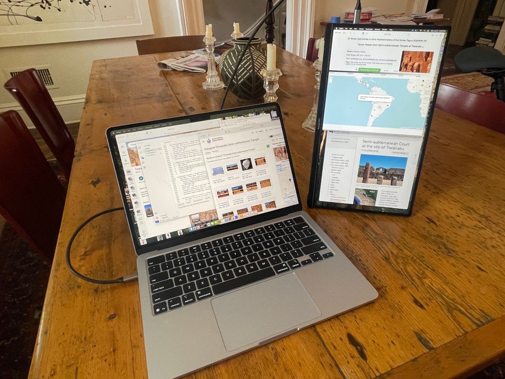 Portable lcd monitor to right of MacBook Air. 