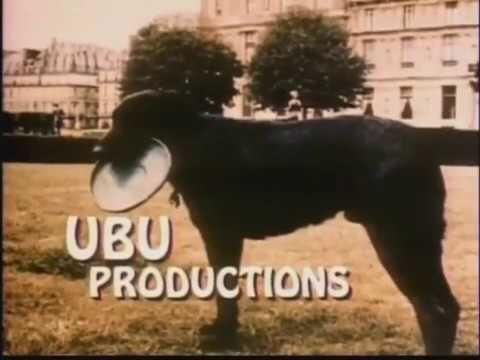 A dog standing in a park with a Frisbee in its mouth and the words Ubu Productions below.