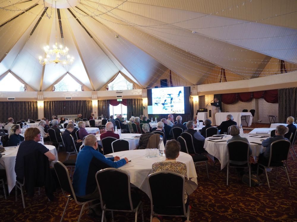 Conference delegates sat in the Atholl Suite (conference room set up with cabaret seating style) listening to a talk.