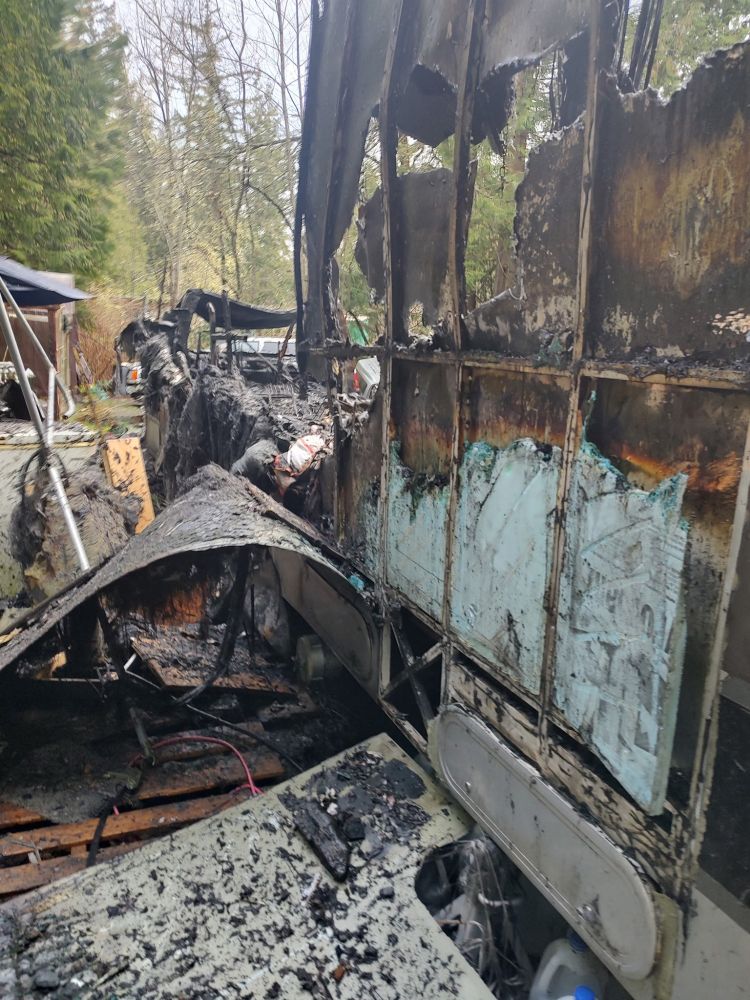 A segment of an RV's exterior wall. The heat of the fire has melted through the aluminum panels. 