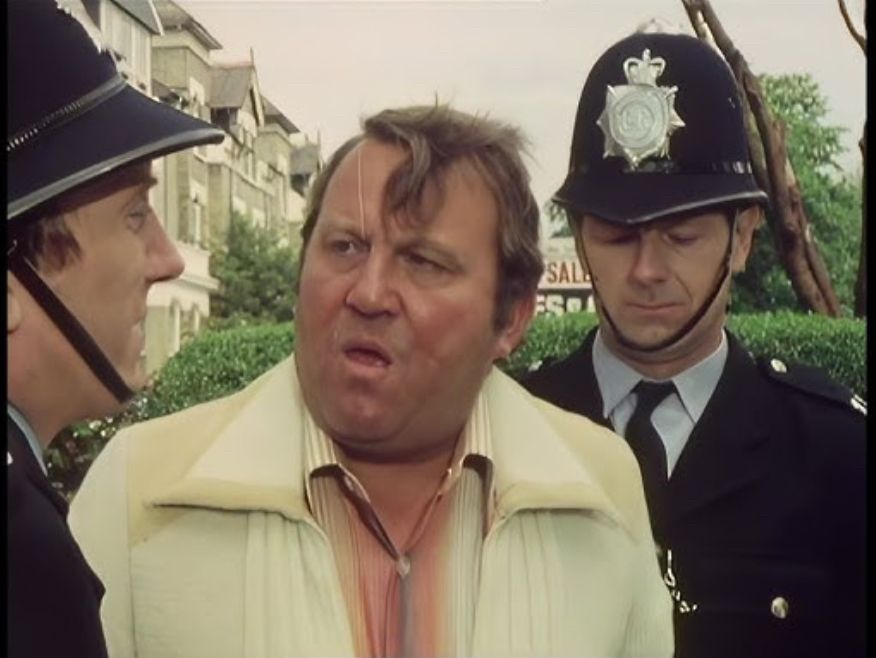 Terry Scott being accosted by two policemen 
