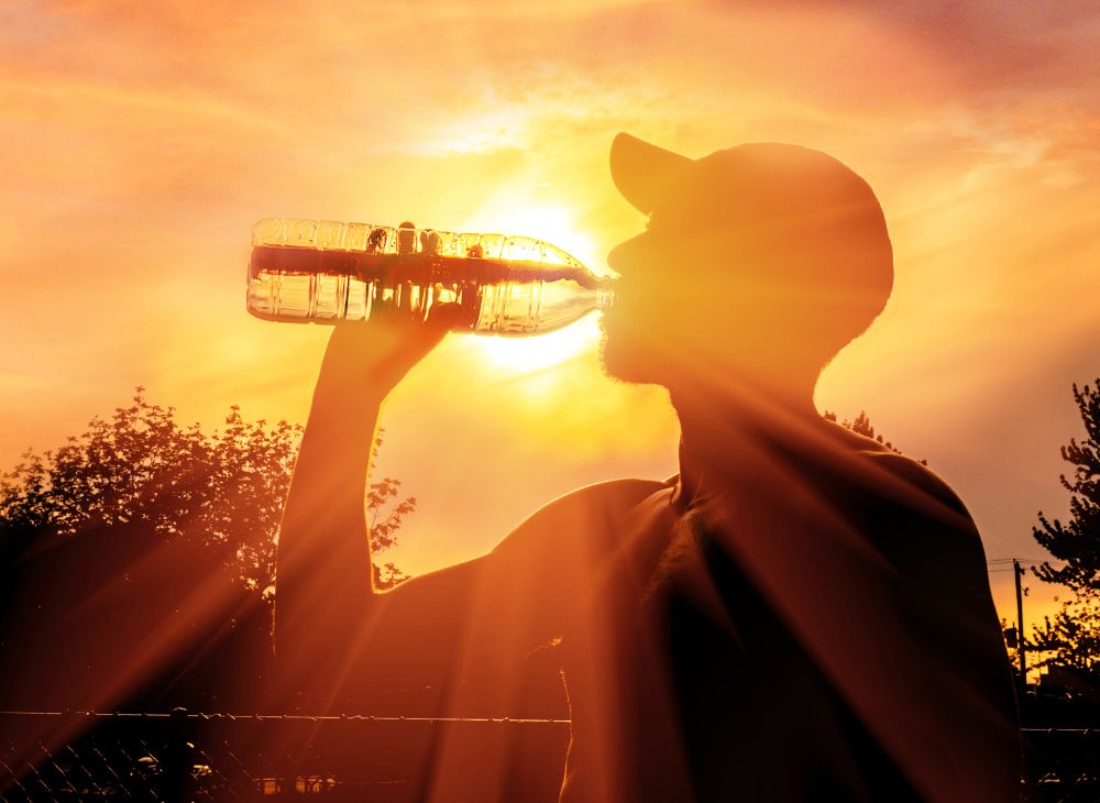 Man drinking water in heat wave
