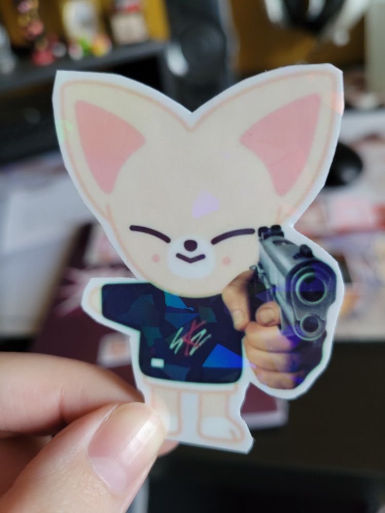 Sticker of foxi.ny with a gun