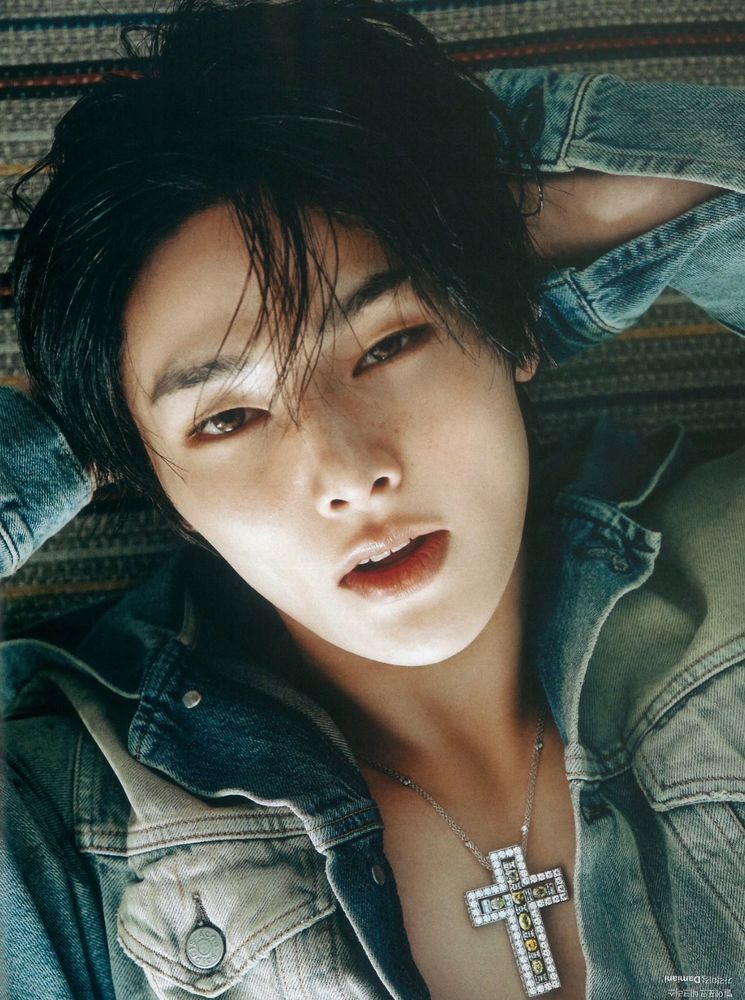 Jeongin laying back with his hands behind his head for cosmopolitan