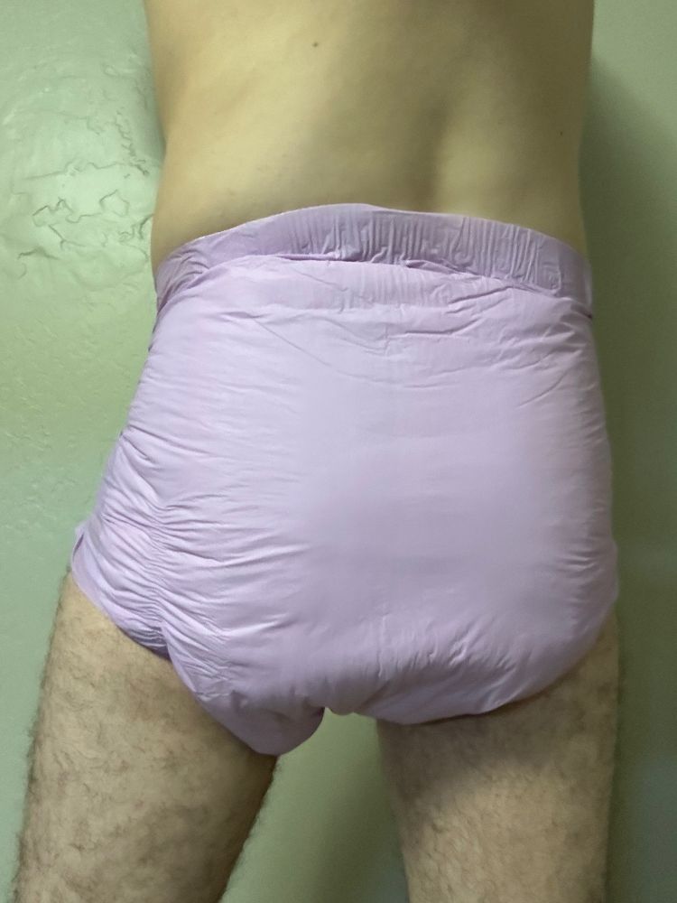 Slim guy in a purple Trest adult diaper, size small.  View of back.