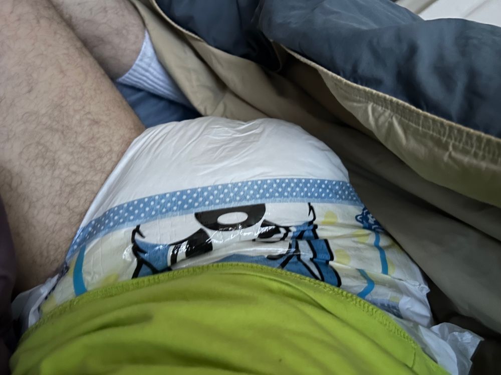 Slim guy waking up in a wet and squishy blue husky PeekABU diaper.
