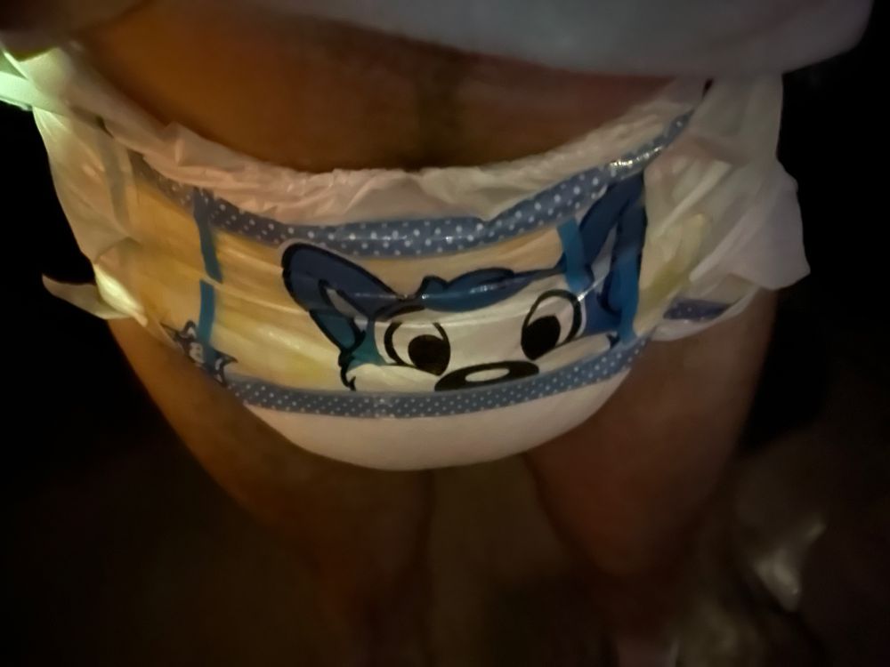 Guy in a Peekabu diaper at an outdoor bar patio wearing a shirt and shoes, but no pants.