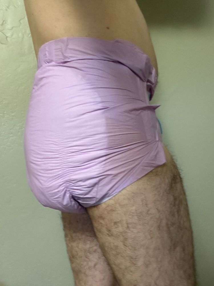 Slim guy in a purple Trest adult diaper, size small.  View of right side.