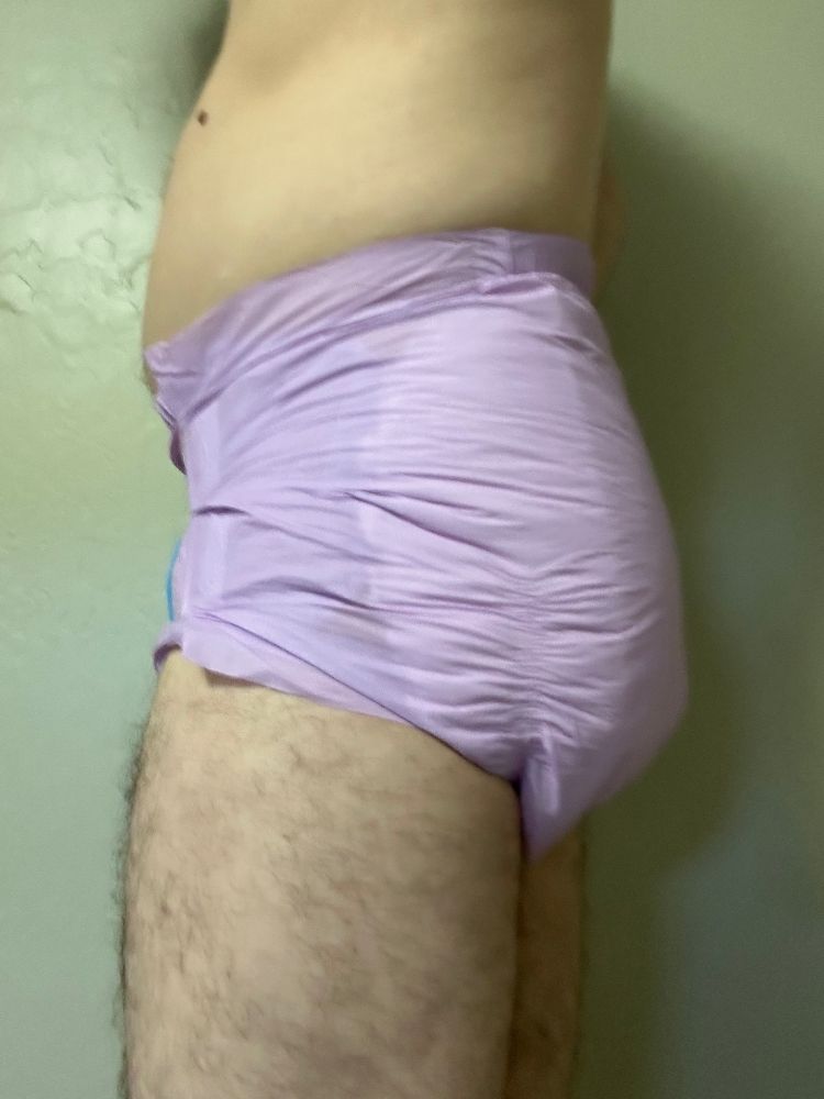 Slim guy in a purple Trest adult diaper, size small.  View of left side.