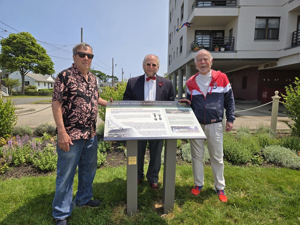 From left: Herb Crehan, Steve Greenberg, and Dennis Riley at the newly installed storyboard exhibit for the first night baseball game in Hull, Massachusetts.