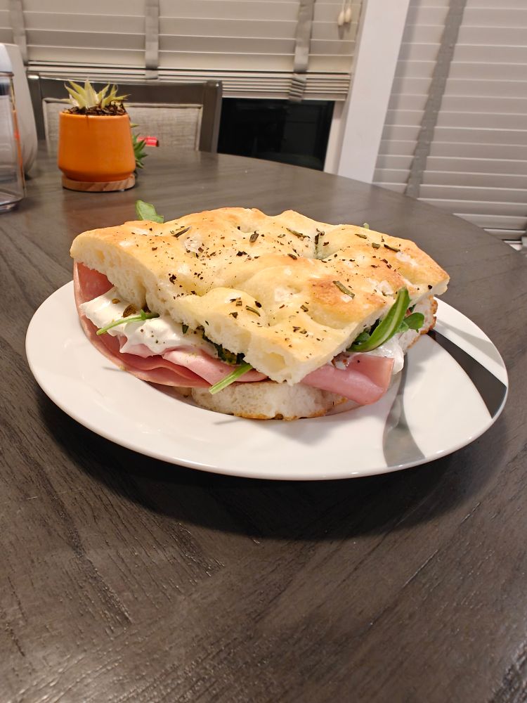 The sandwich has mortadela, burrata, arugula and pistachio pesto.