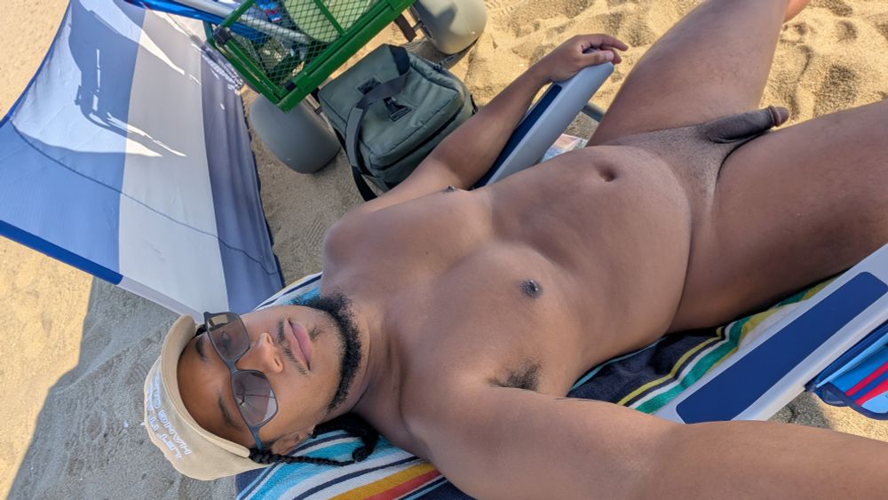 Me reclining in my beach chair. Naked but wearing a cap and glasses. 