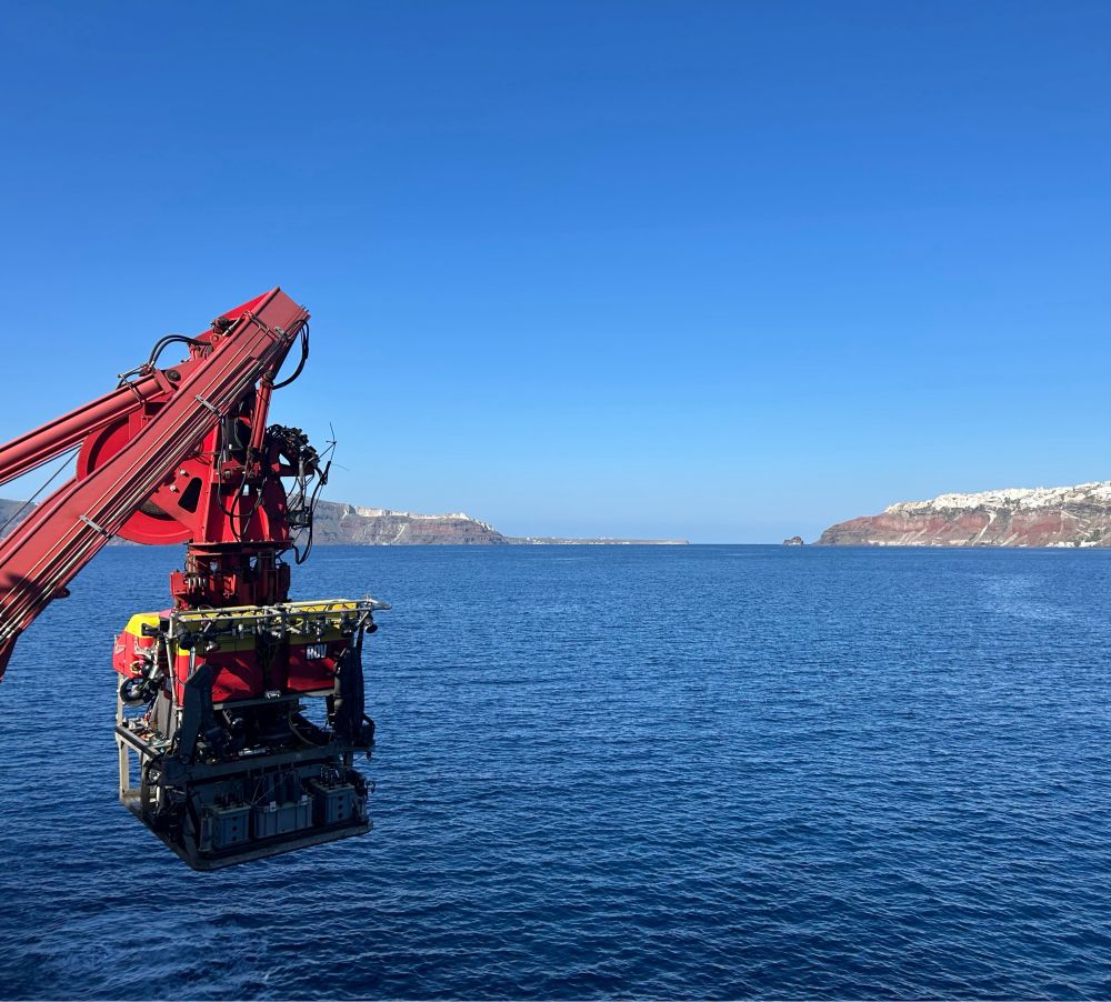 Remotely operated vehicle Isis about to deploy against the background of Santorini on a sunny day.