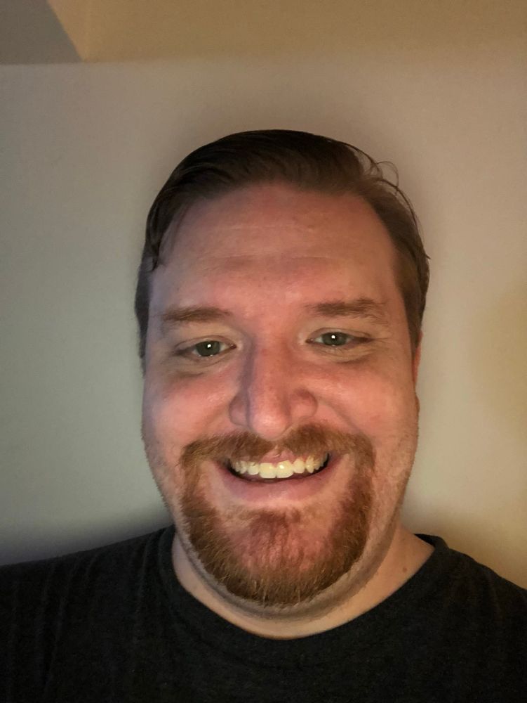 Rowan’s former look, way back in 2018, with a goatee and somewhat of a facsimile of a smile