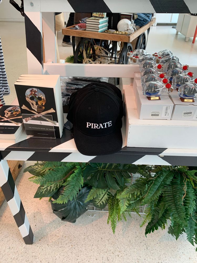 black cap with the word “pirate” written in white