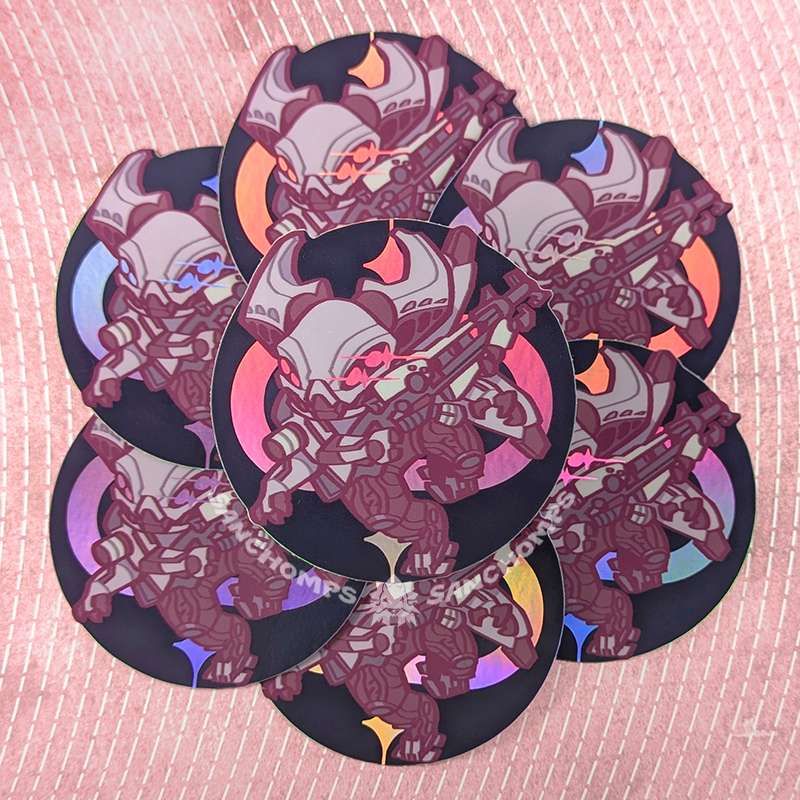 Sticker based on Atraks-1 from Destiny 2. The sticker material is holographic, which shifts in a rainbow of color.