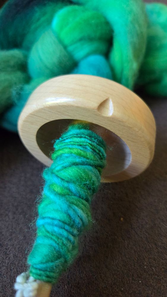 Closeup of the spindle with yarn spun from the top
