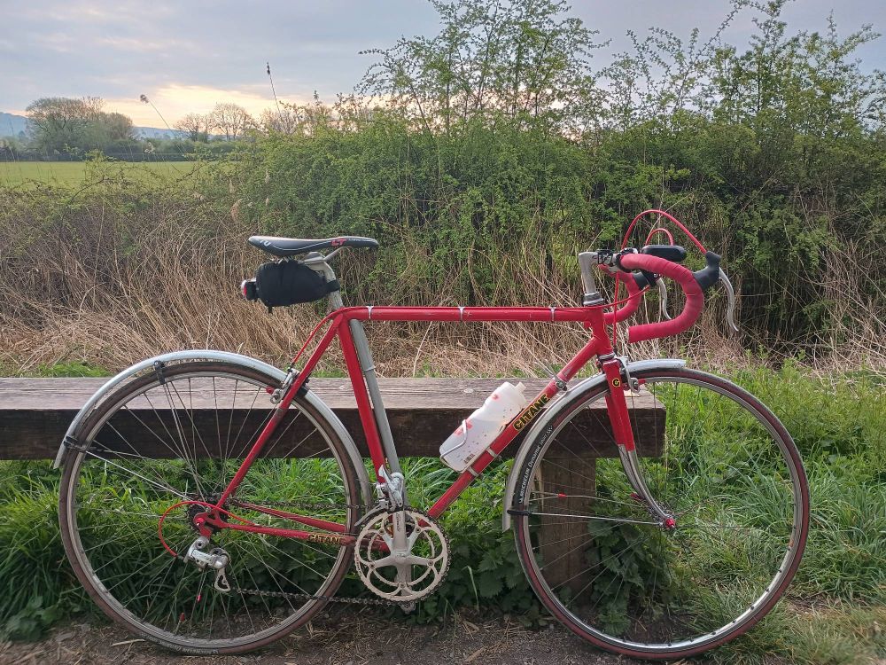 Red Gitane Course bicycle by a bench