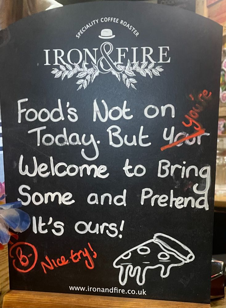 Chalkboard sign in a pub: "Food's not on today, But your welcome to bring some and pretend it's ours!" Someone has corrected "your" to "you're" and written "B-, nice try!"