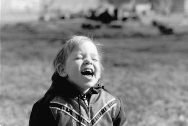 Baby picture of me. B&W outdoor shot. 1979 ish and my head is back in laughter.