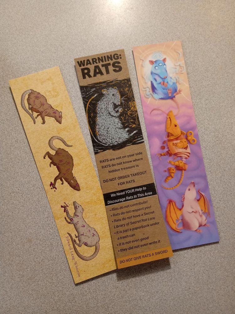 Three bookmarks from Ratti Incantati with rat related artwork and random tables. Rats in all different styles from sketchy to fantastic and bizarre clockwork and esoteric.