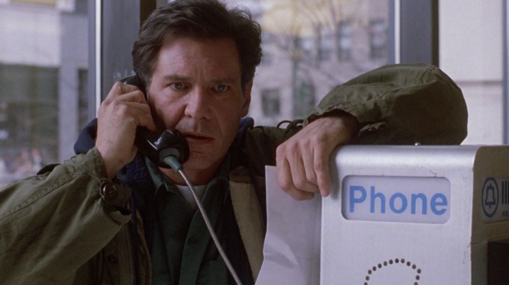Harrison Ford in Fugitive on the run from the law talking on a payphone.